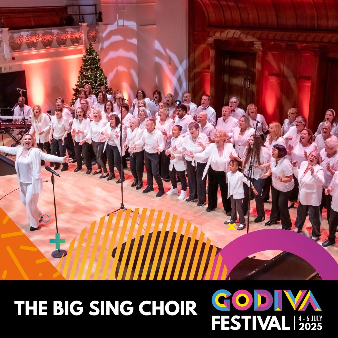 Choir group performing on stage facing a conductor