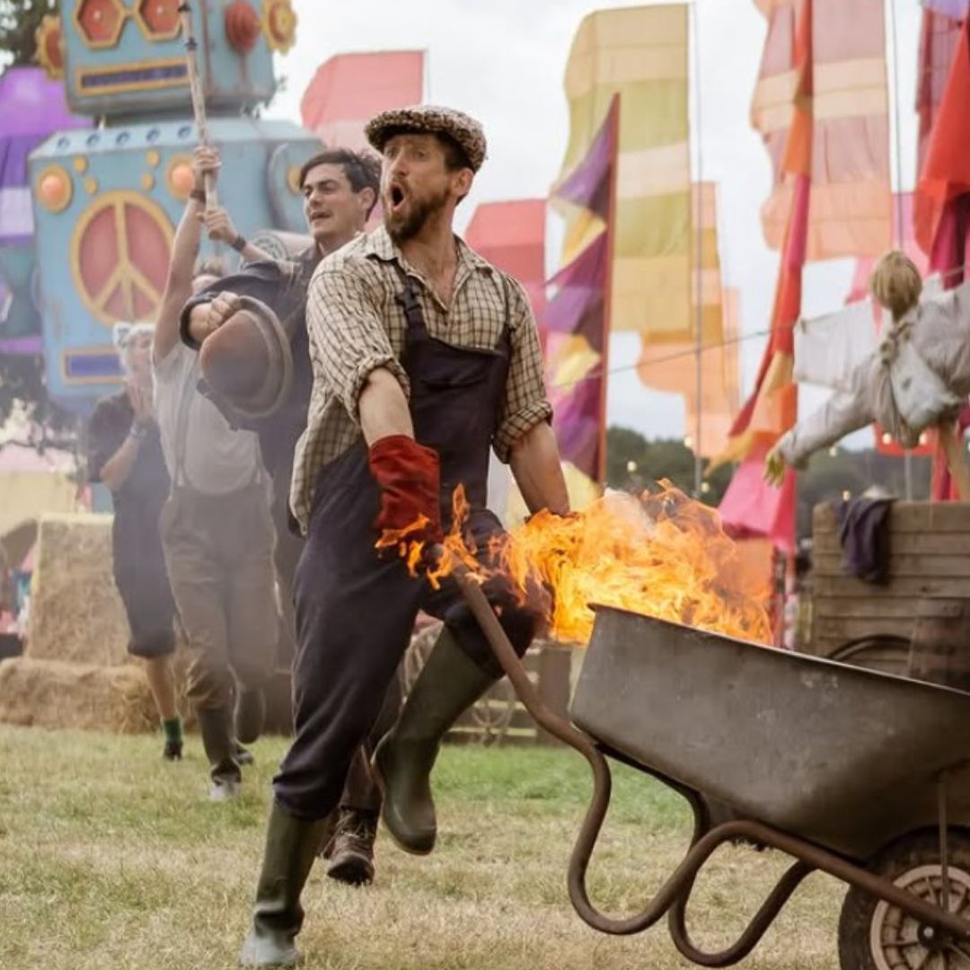 Man running with wheelbarrow on fire