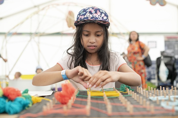 A girl doing an activity in the tent