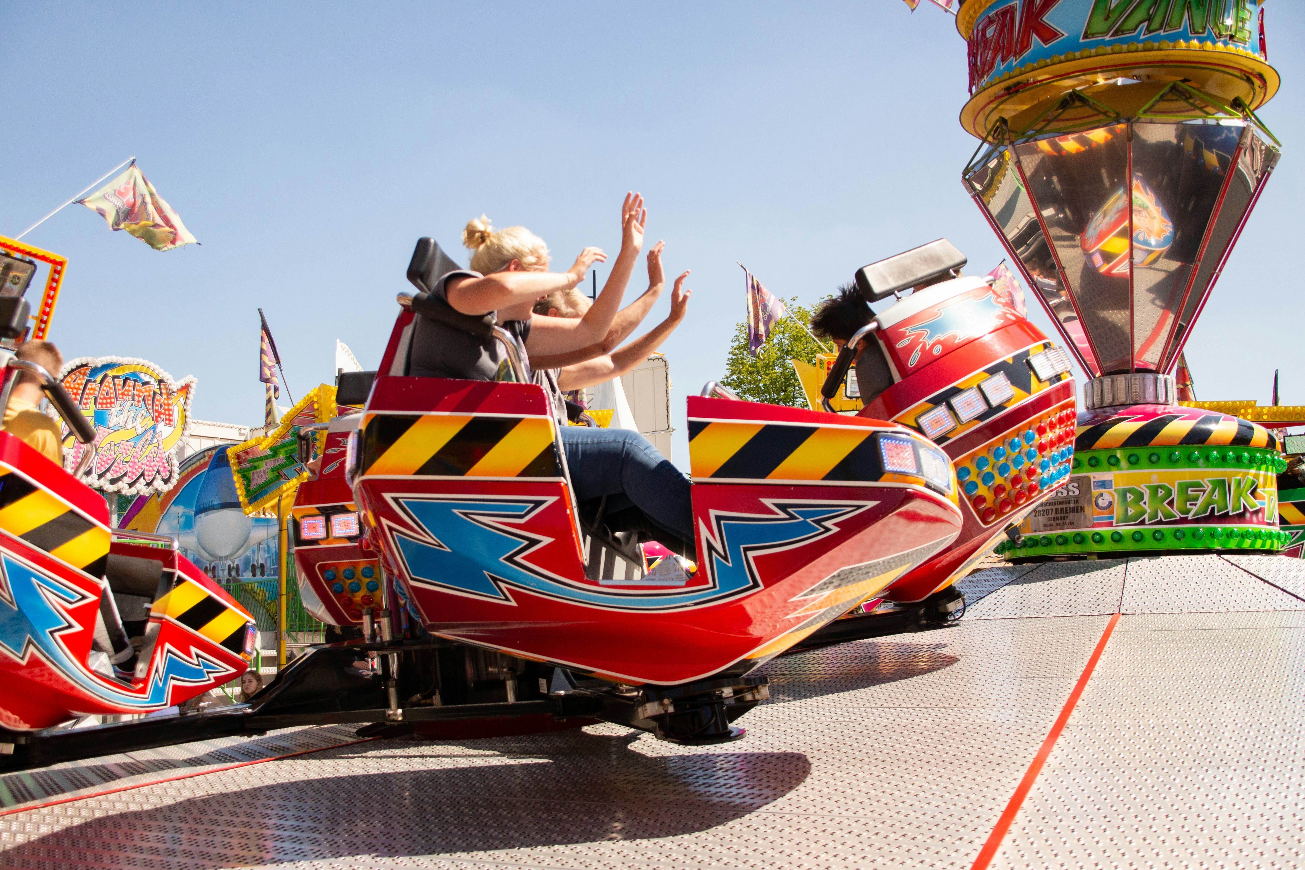 Photo of people on a funfair ride on a  sunny day